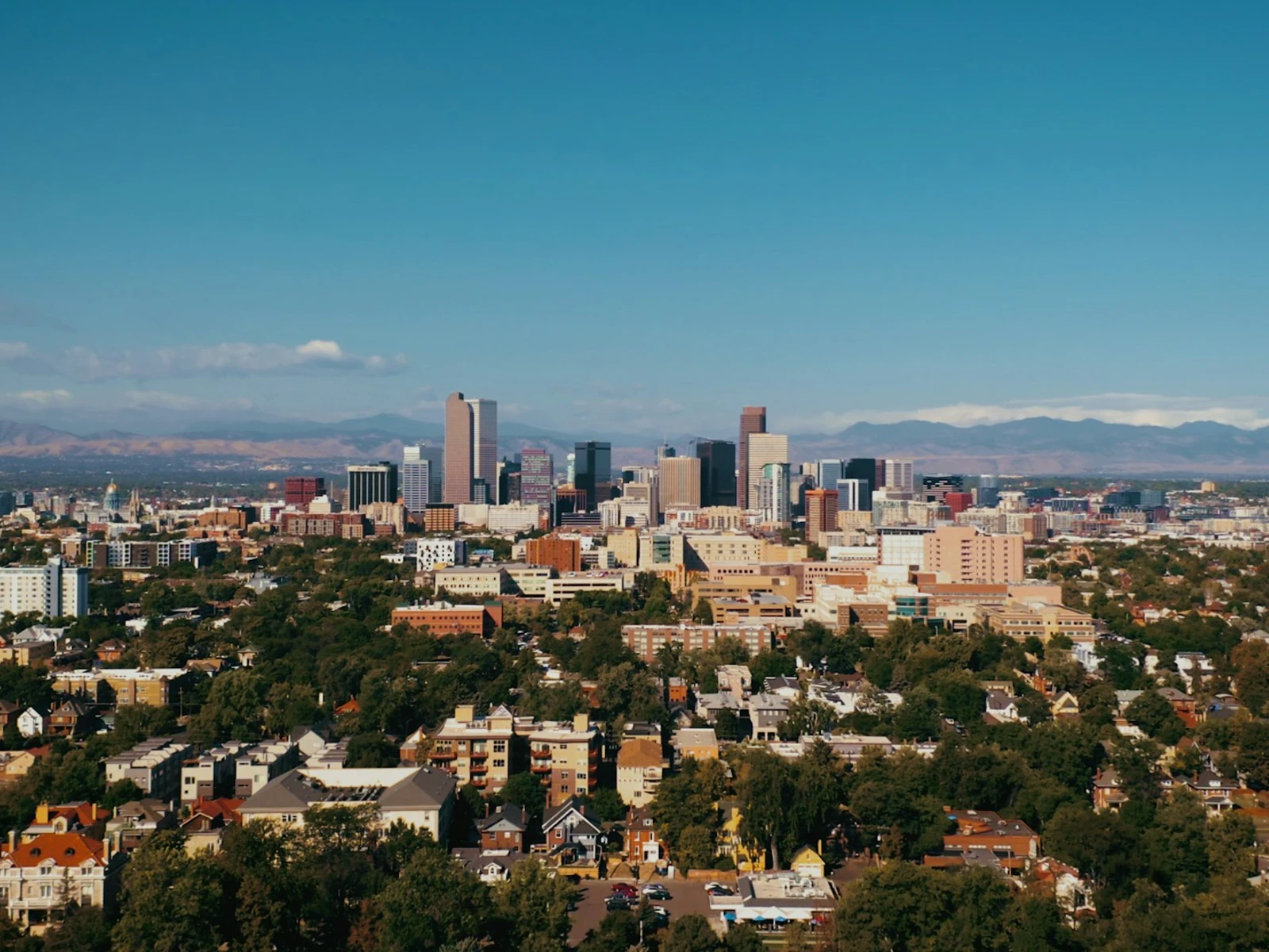 Downtown Denver skyline with the Rocky Mountains behind it